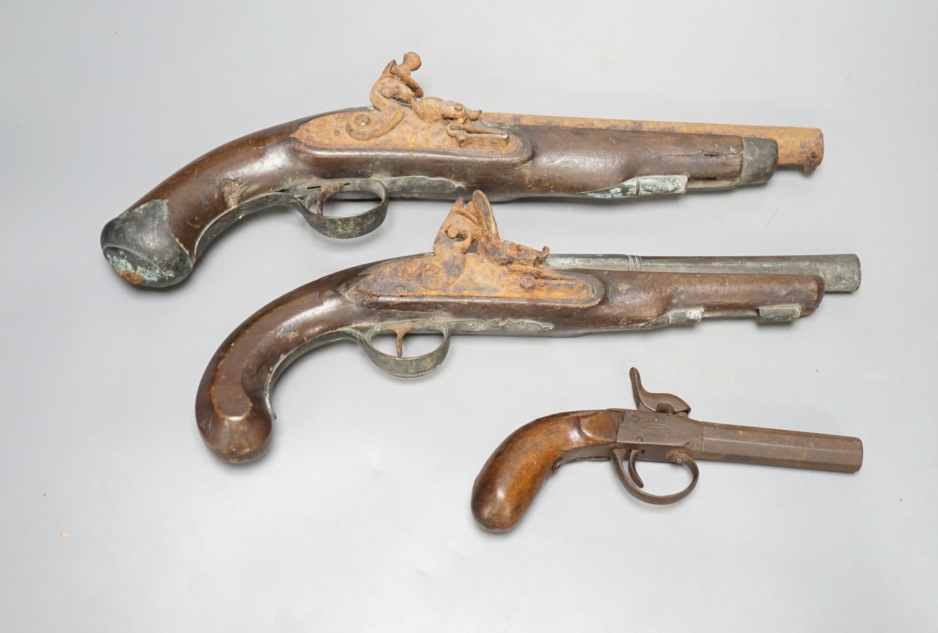 Two 19th century flintlock pistols and a pocket pistol, largest 40 cms long.